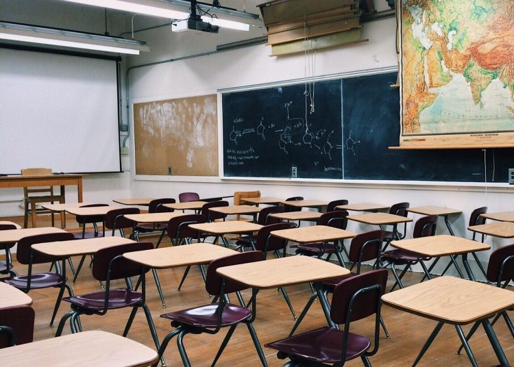 Classroom with blackboard and desks