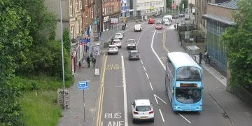 Cars and bus driving on road in Glasgow