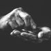 Older hands with coins representing poverty in older adults