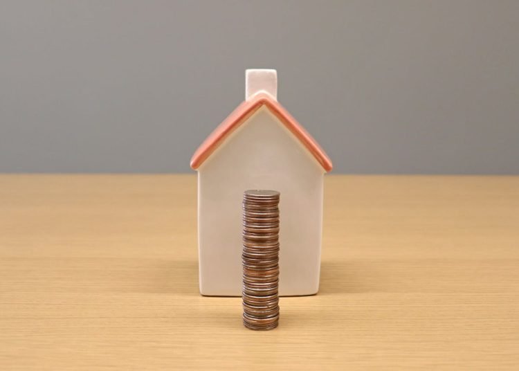 A house and coins representing wellbeing economy