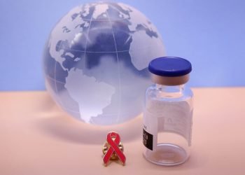 Picture of the world with a HIV vaccine vial