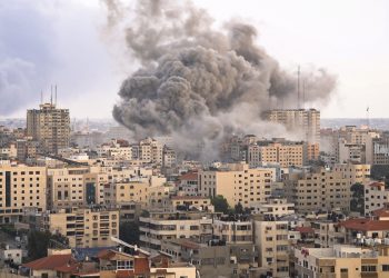Buildings being bombarded in Gaza as an act of genocide