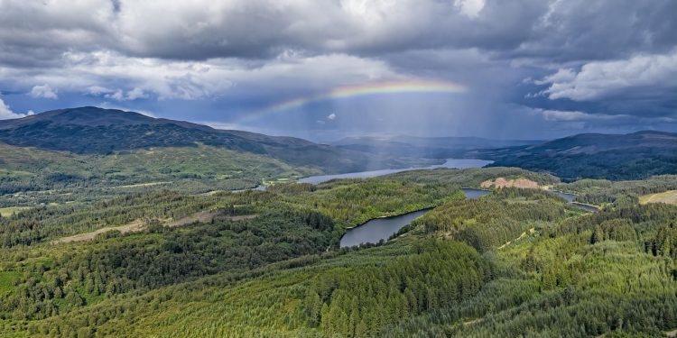 A photograph of Scotland at Queen Elizabeth Park with a rainbow, symbolising hope