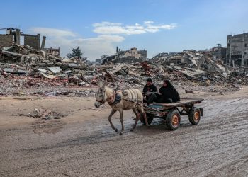 Gaza-Palestine Amid the massive destruction in Jabalia camp, a young man and his mother drive a cart through the camp's streets