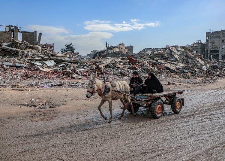 Gaza-Palestine Amid the massive destruction in Jabalia camp, a young man and his mother drive a cart through the camp's streets
