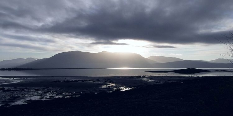 A photo of Loch Linnhe with the sun between the clouds