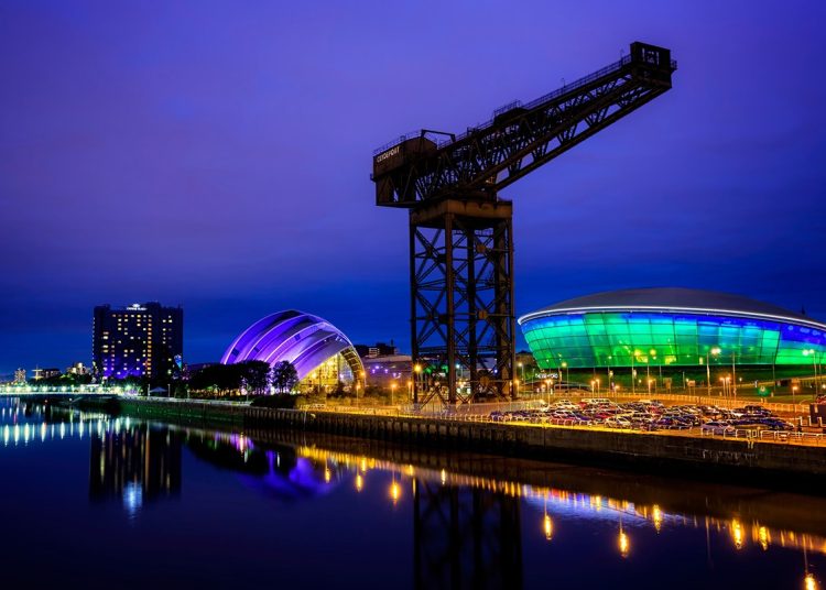 Glasgow, Scotland - September 21, 2015: The redeveloped docklands area of Glasgow at night, with the Clyde Auditorium, the Hydro and Finnieston Crane.
