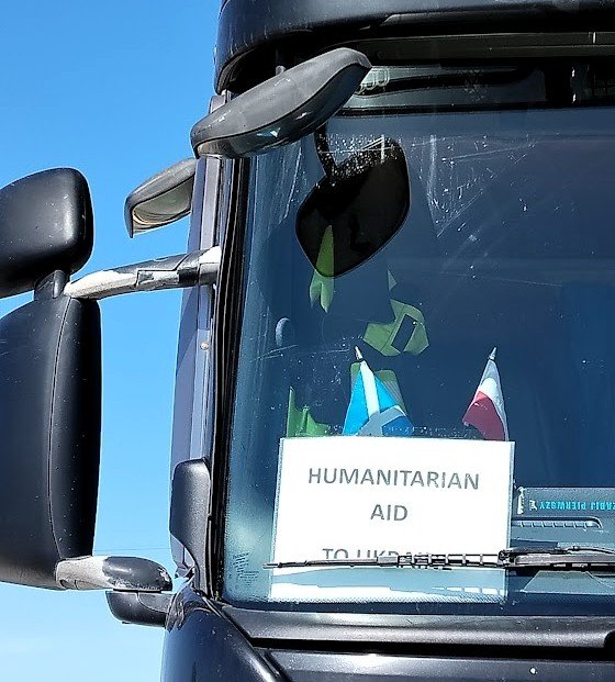 Sign in the front window of as truck, saying 'Humanitarian Aid to Ukraine'